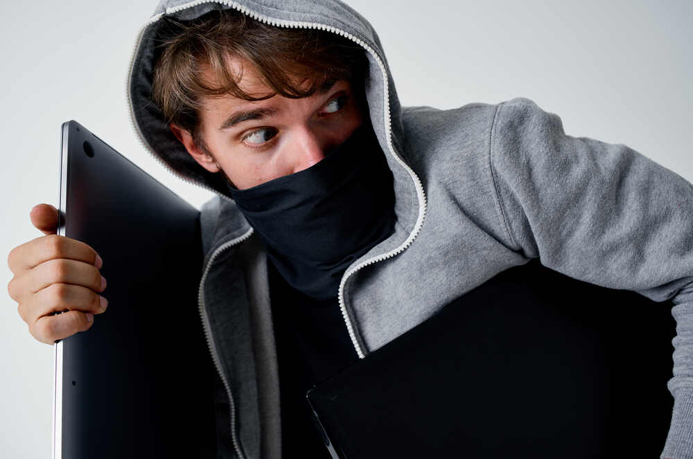 Young criminal stealing