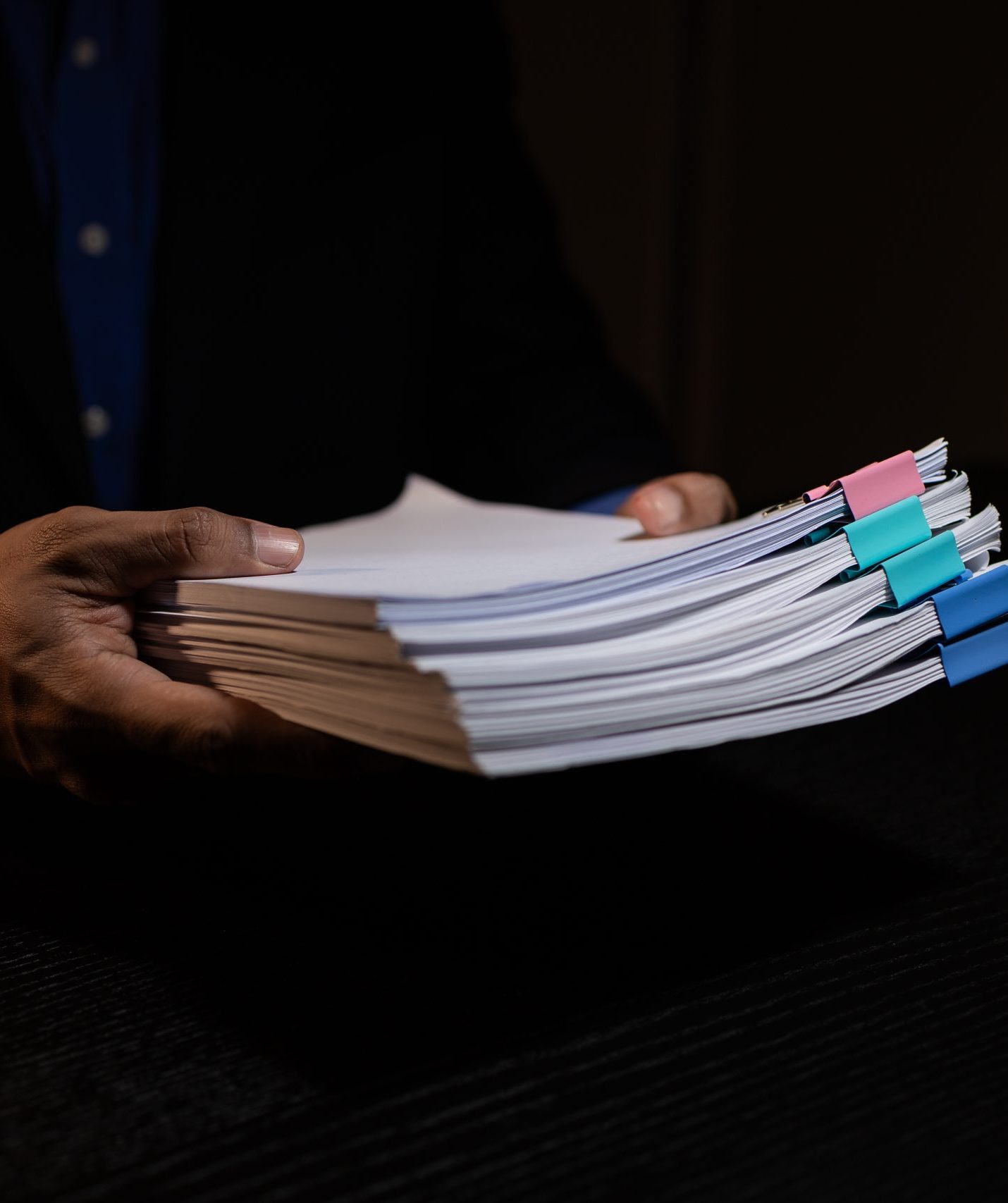 a businessman works overtime is his accounting firm's office until late at night, an entrepreneur remains at his export company because he has a lot of customer documents to check